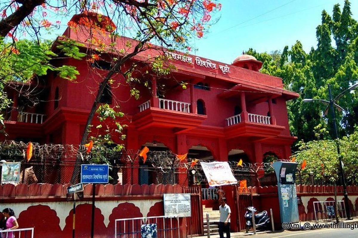 a red building with people standing in front of it