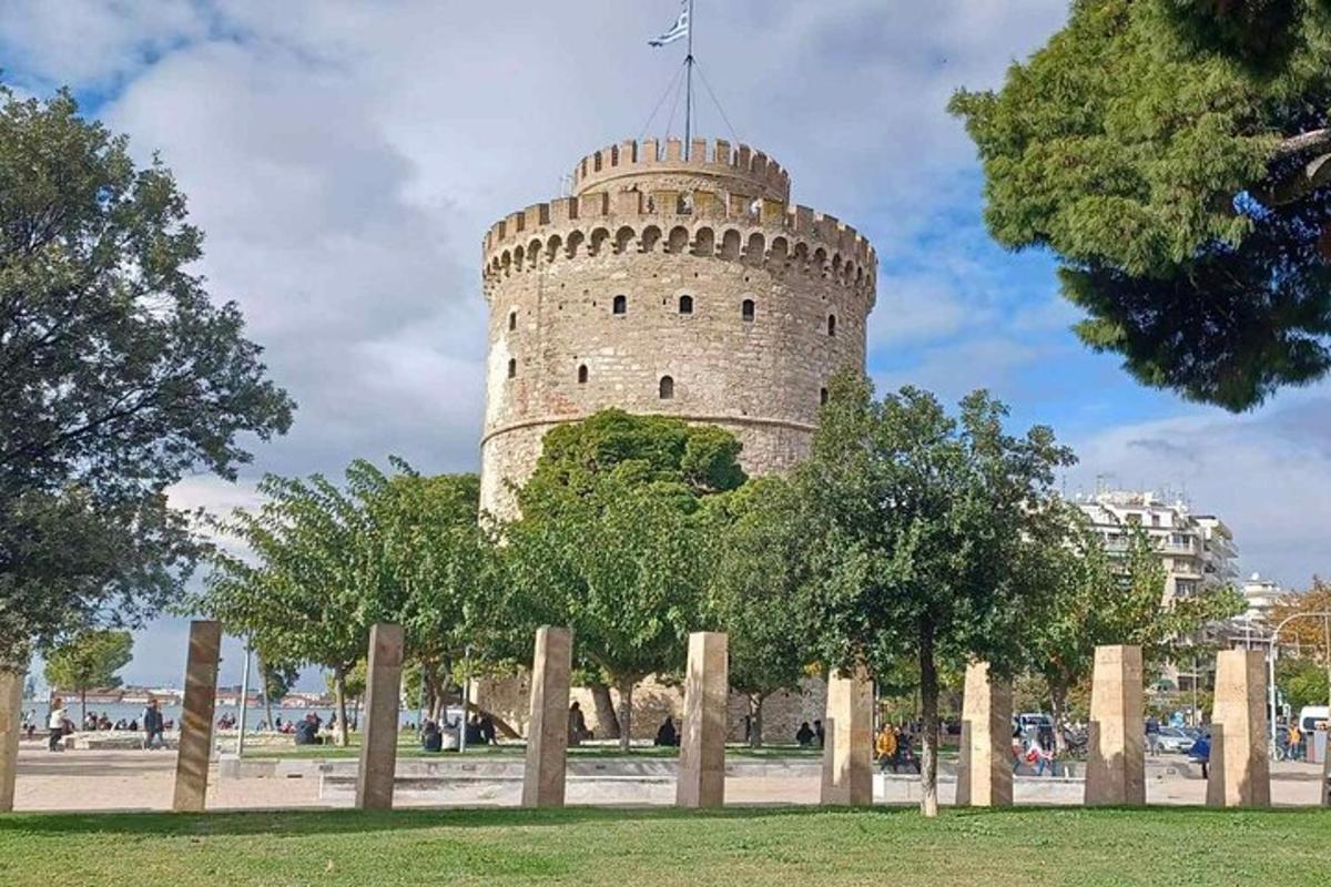 a white tower with a fence in front of it
