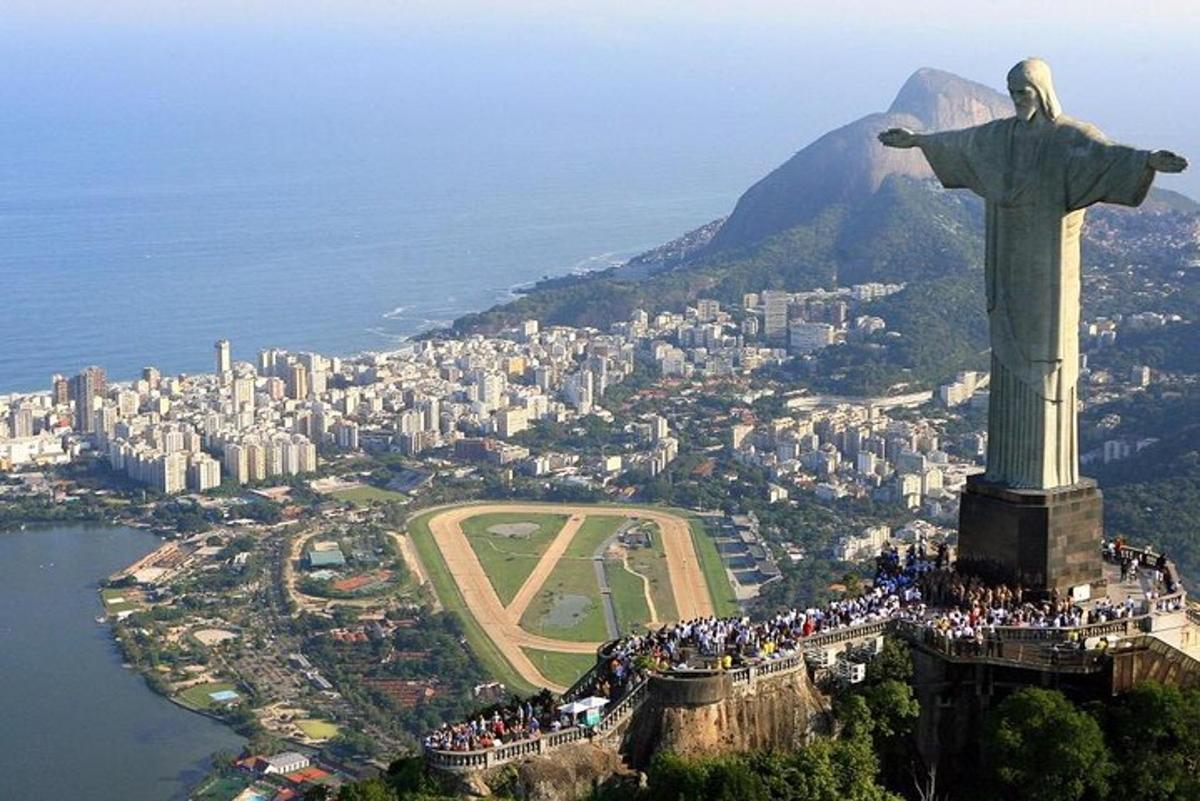 a group of people standing on the christ the redeemer statue