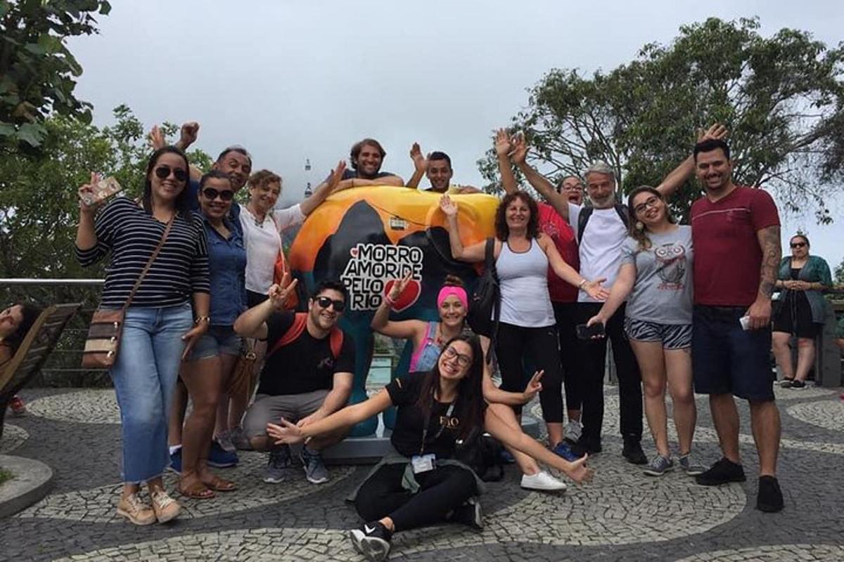 a group of people posing for a picture in front of a statue