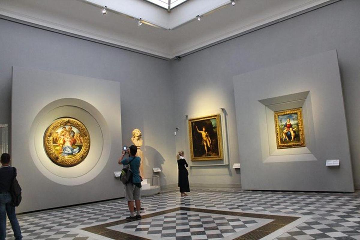 un grup de persones mirant quadres en un museu