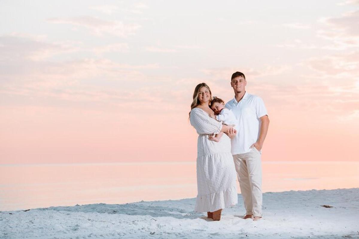 a family poses for a picture on the beach