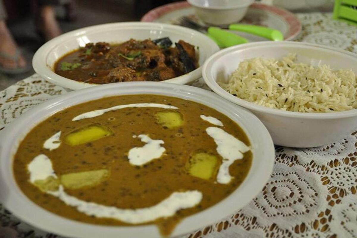 a table with three bowls of food and rice