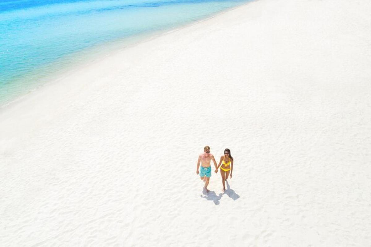 a man and a woman walking on a beach