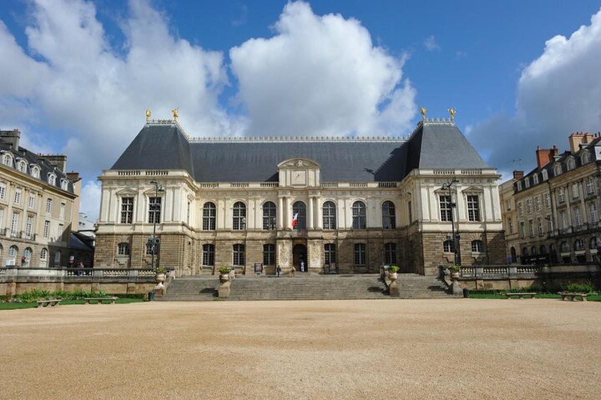 a large white building with a black roof