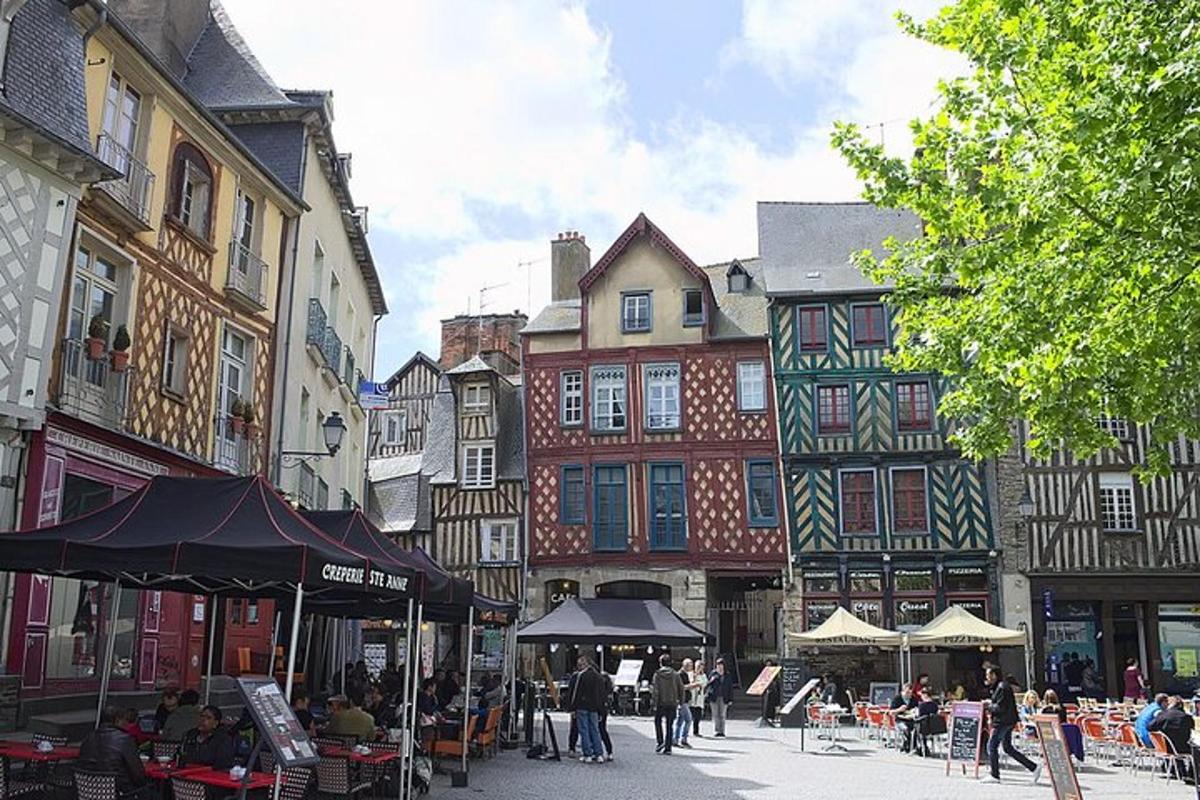 a group of people walking around a street with buildings