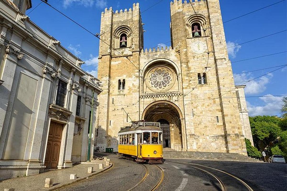 a yellow trolley in front of a church