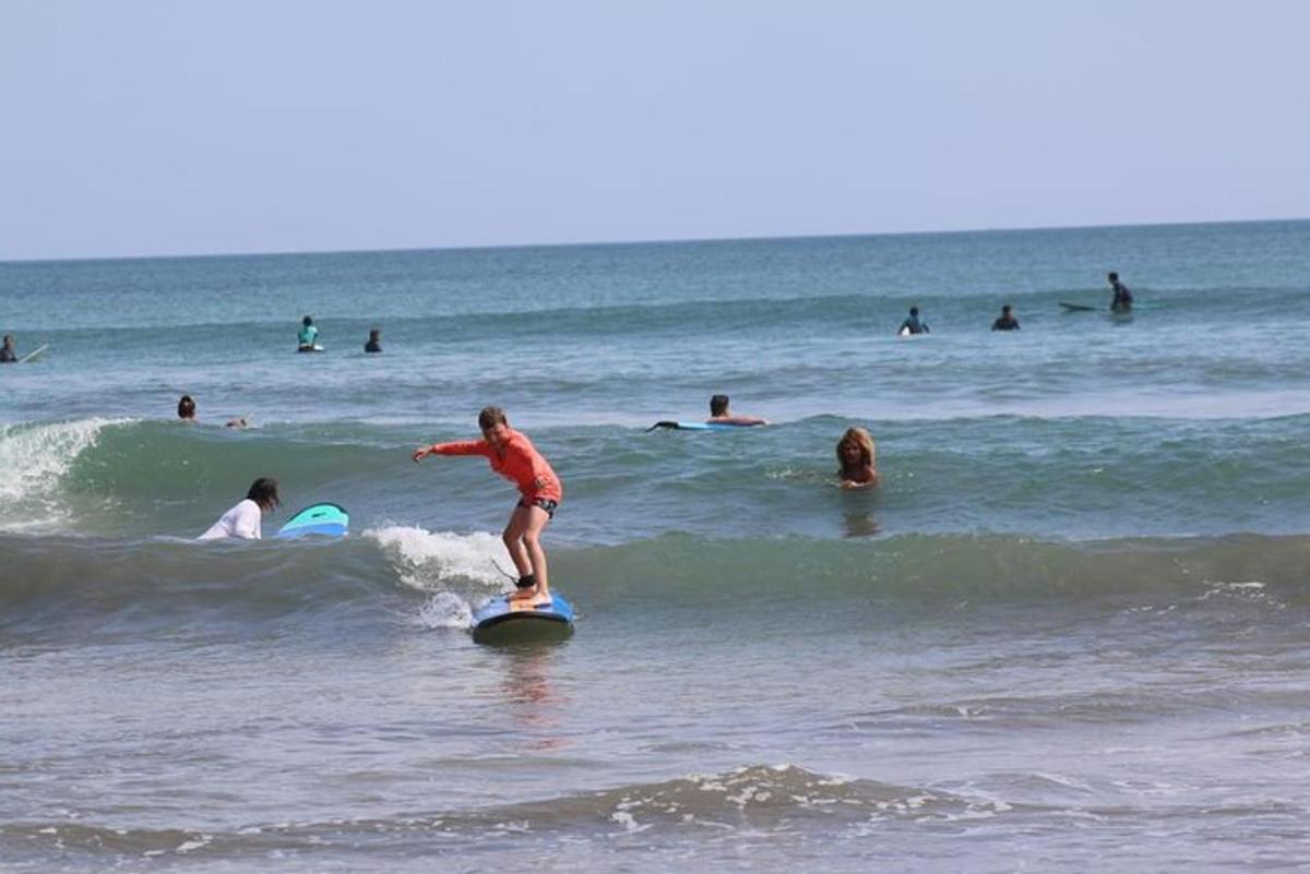 a child riding a wave on a surfboard in the ocean