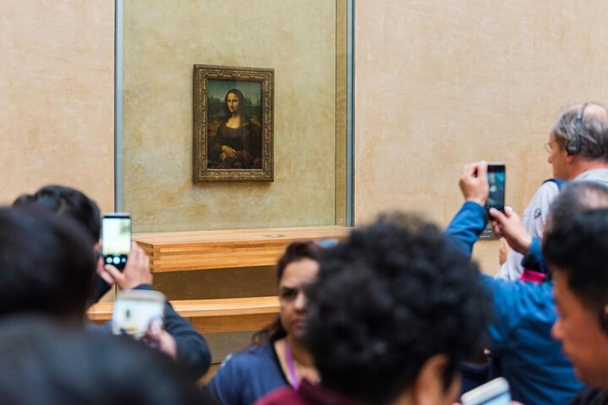 skupina lidí fotografujících obraz