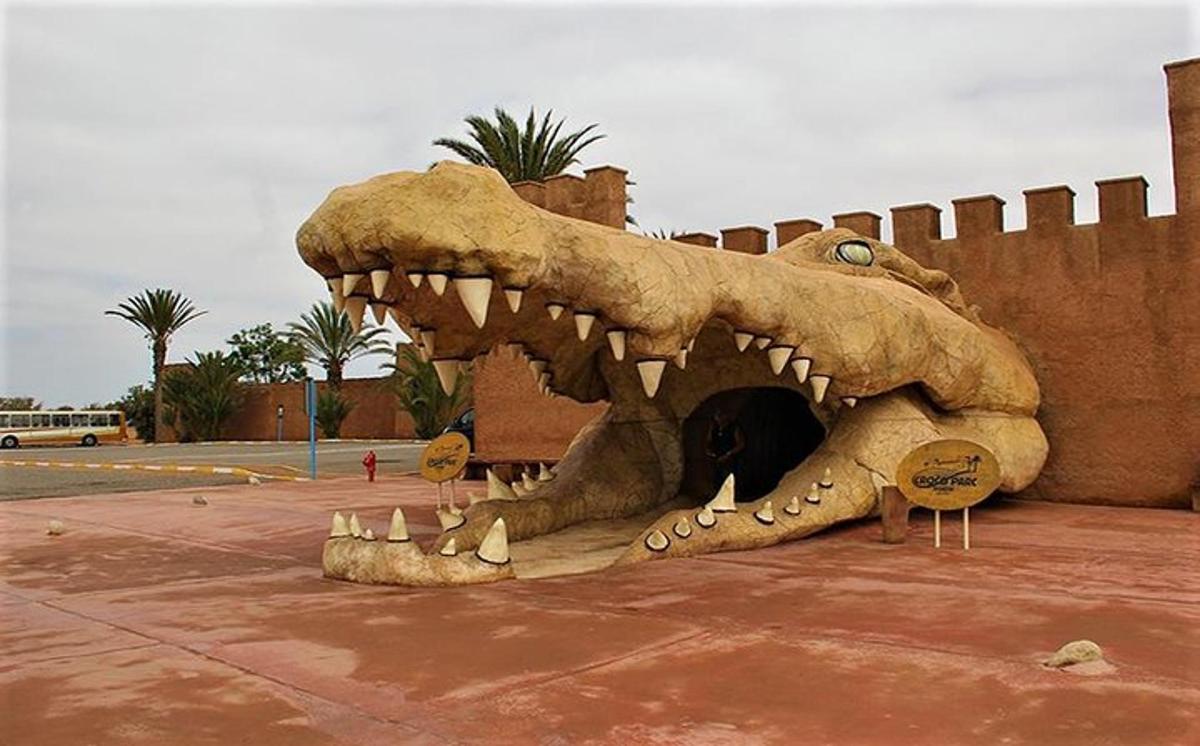 a statue of a dinosaur with its mouth open