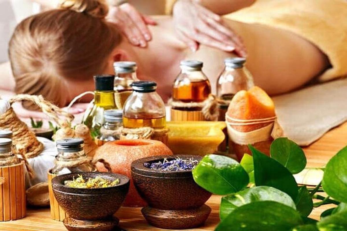 a woman laying in bed in front of a table with cosmetics