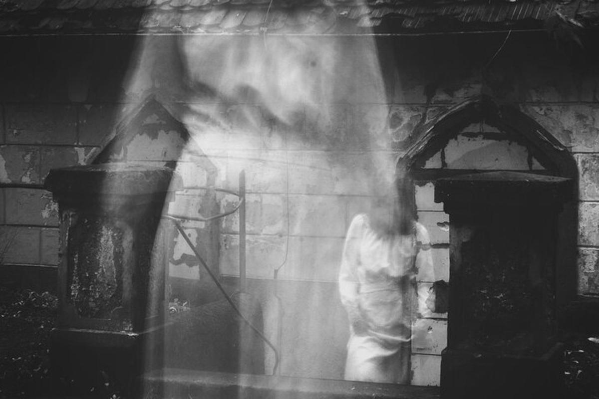 a woman standing in front of a building with smoke
