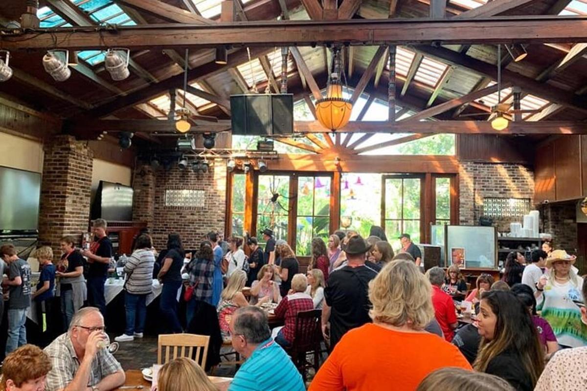a large crowd of people sitting in a restaurant