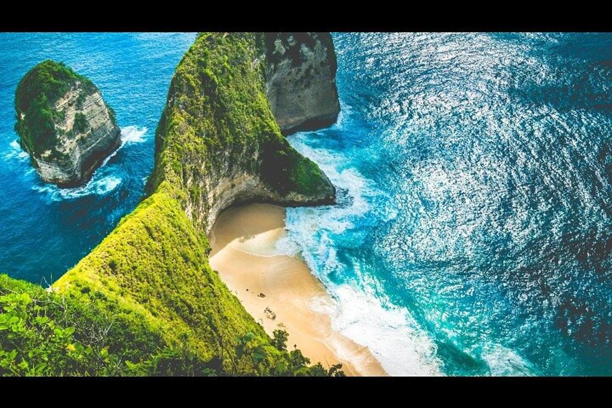 an aerial view of a beach with rocks and the ocean