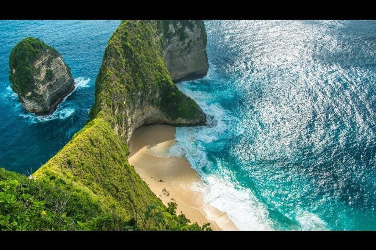an aerial view of a beach with two large rocks