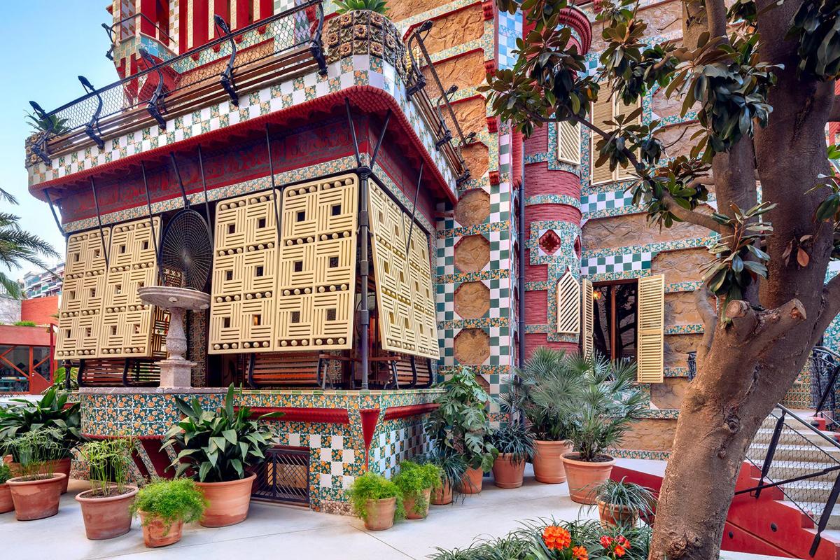 a building with potted plants on the side of it