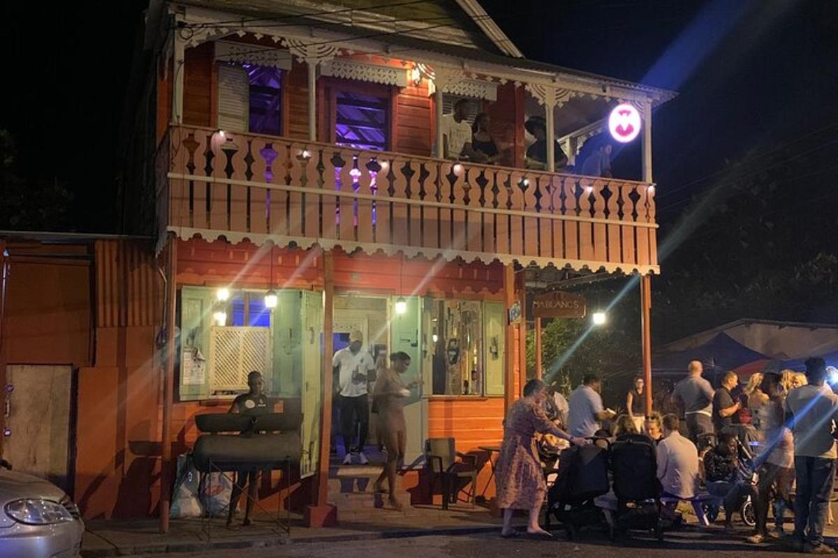 a group of people standing outside of a building at night