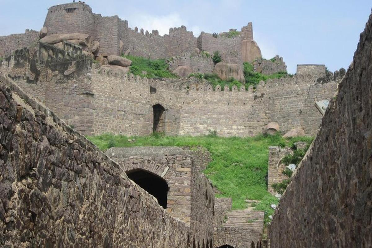 an old stone building with a castle in the background