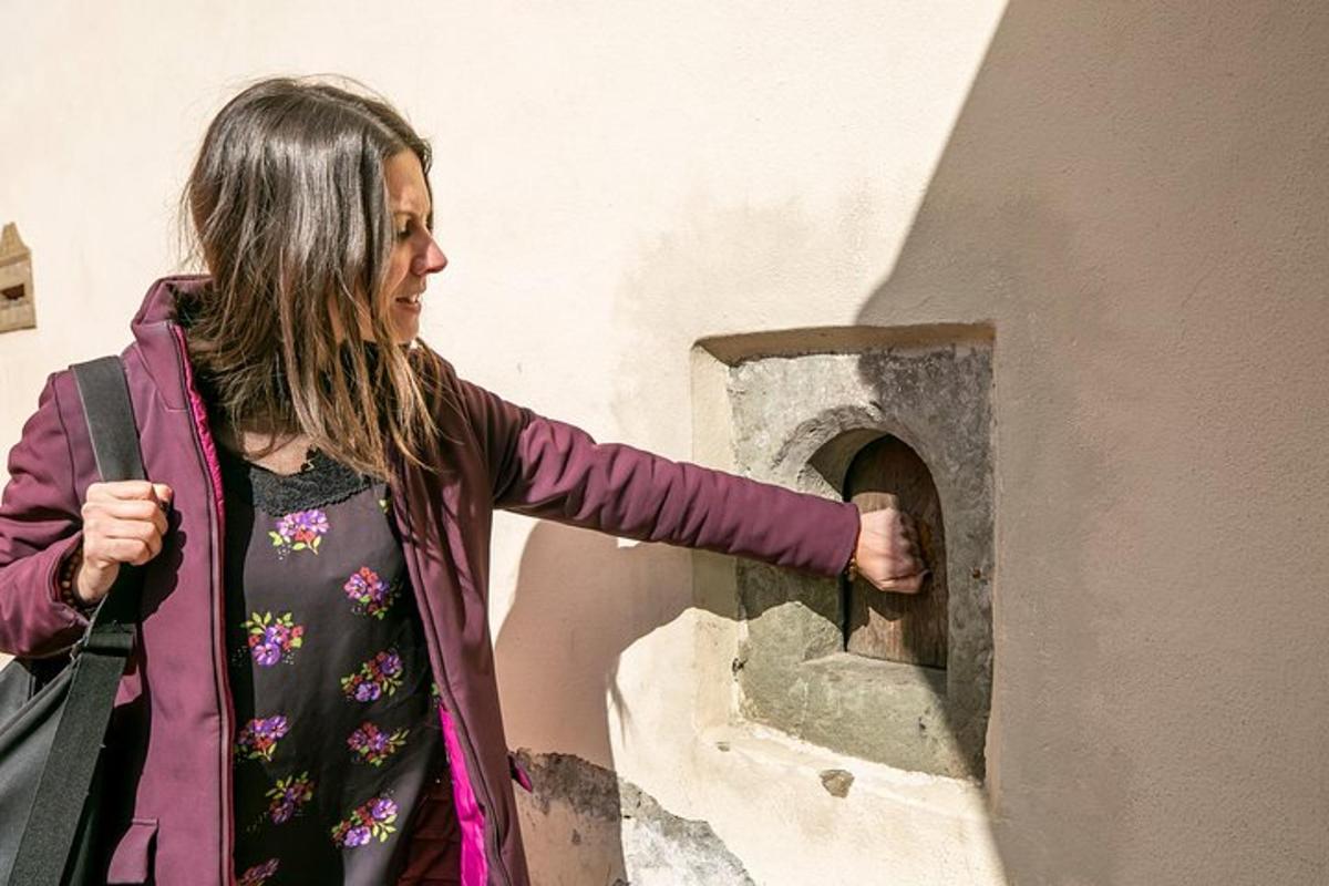 μια γυναίκα βάζει το χέρι της σε έναν φούρνο από τούβλα