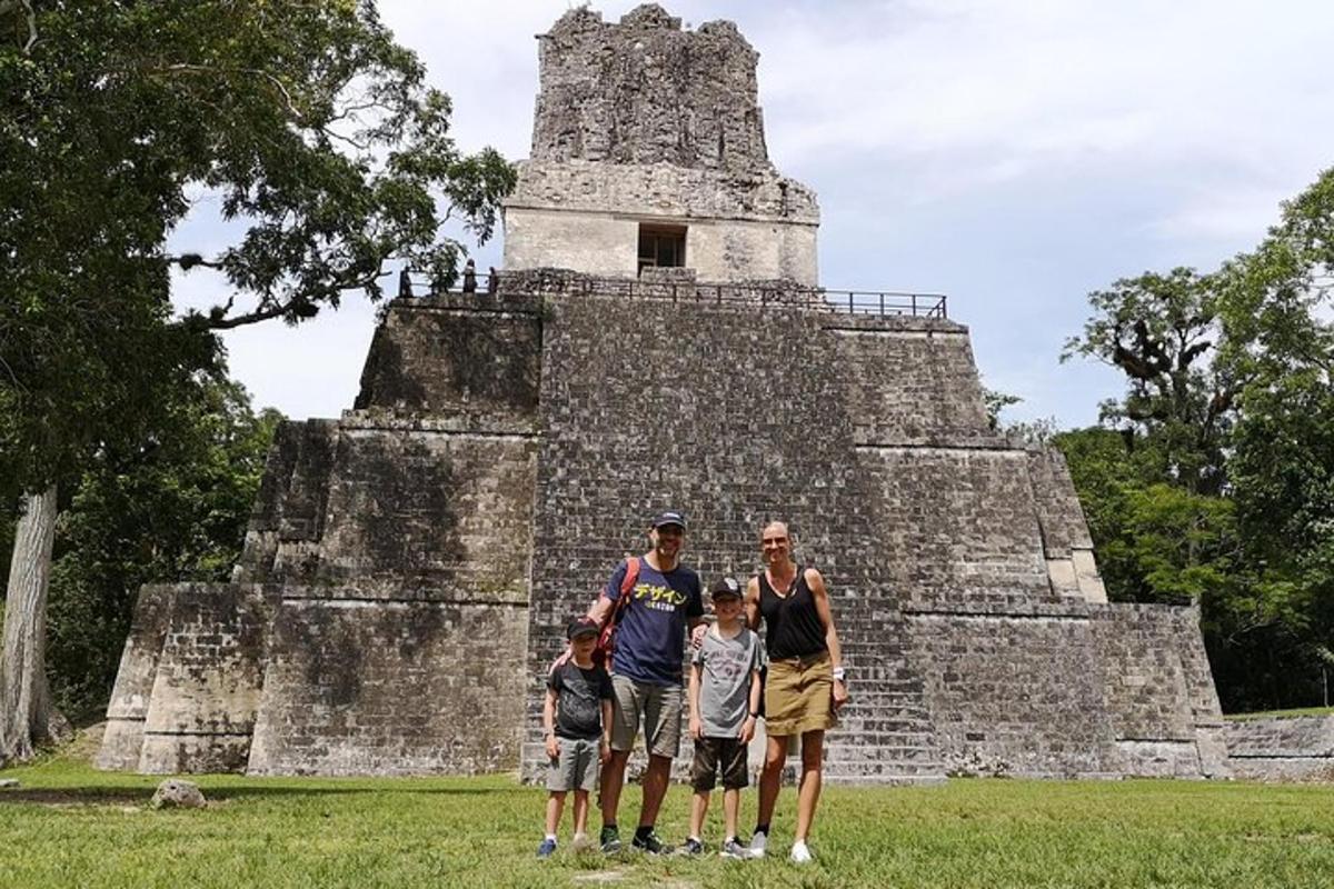 a group of people standing in front of a pyramid