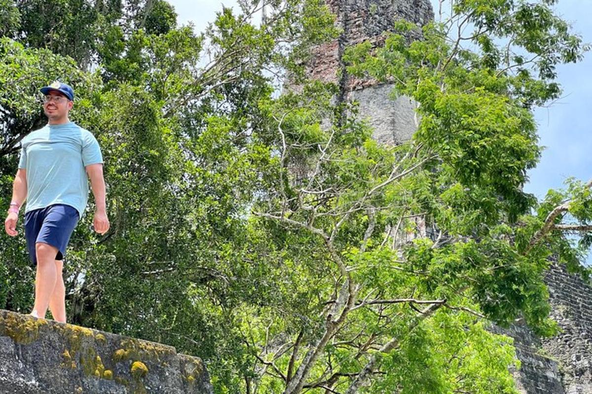 a man standing on top of a stone wall