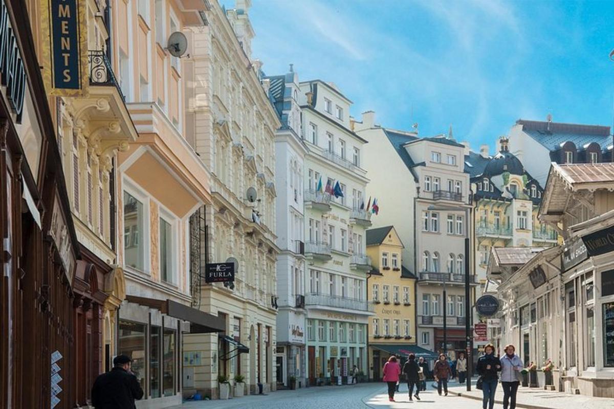 a group of people walking down a street with buildings
