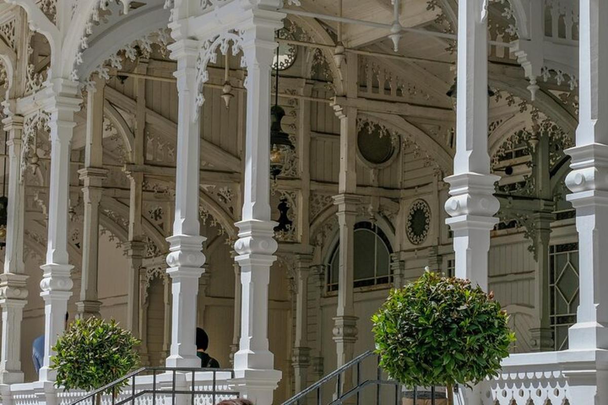a building with two potted plants on a staircase