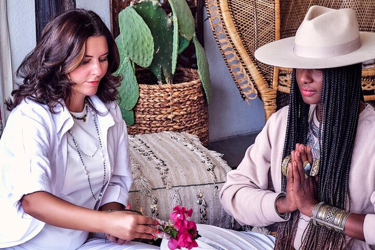 a woman in a hat sitting next to another woman