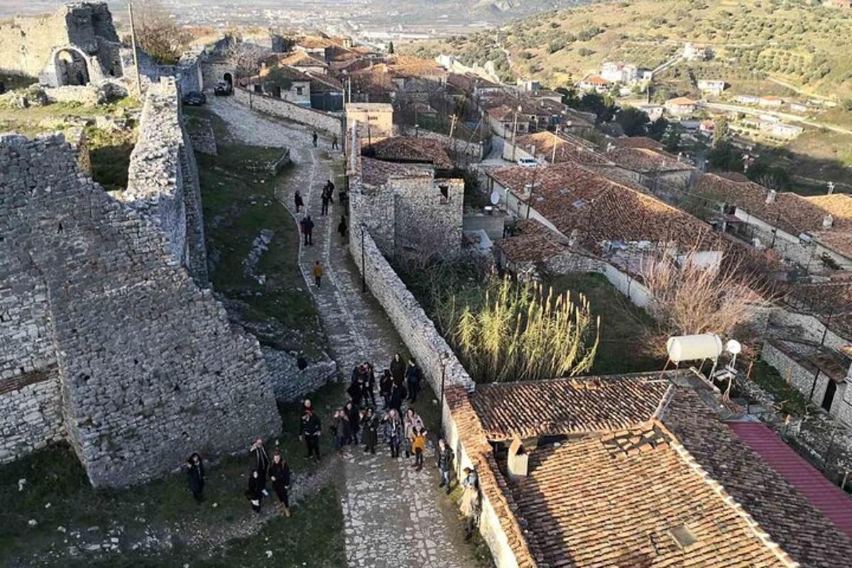a group of people walking along the wall