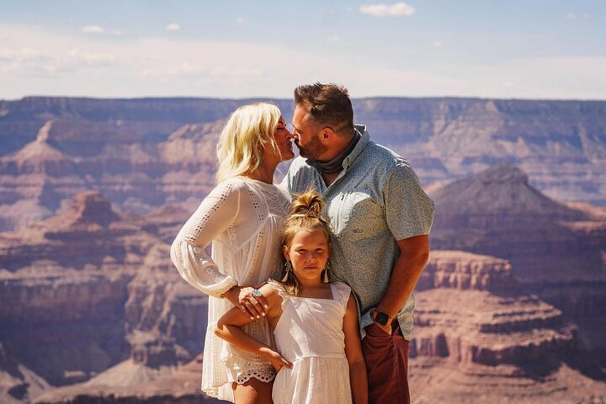 a family posing for a picture at the grand canyon