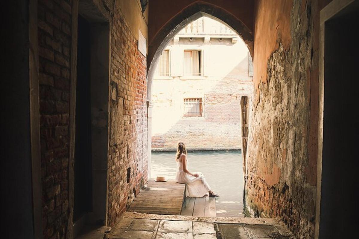 a woman is sitting in the water in an archway