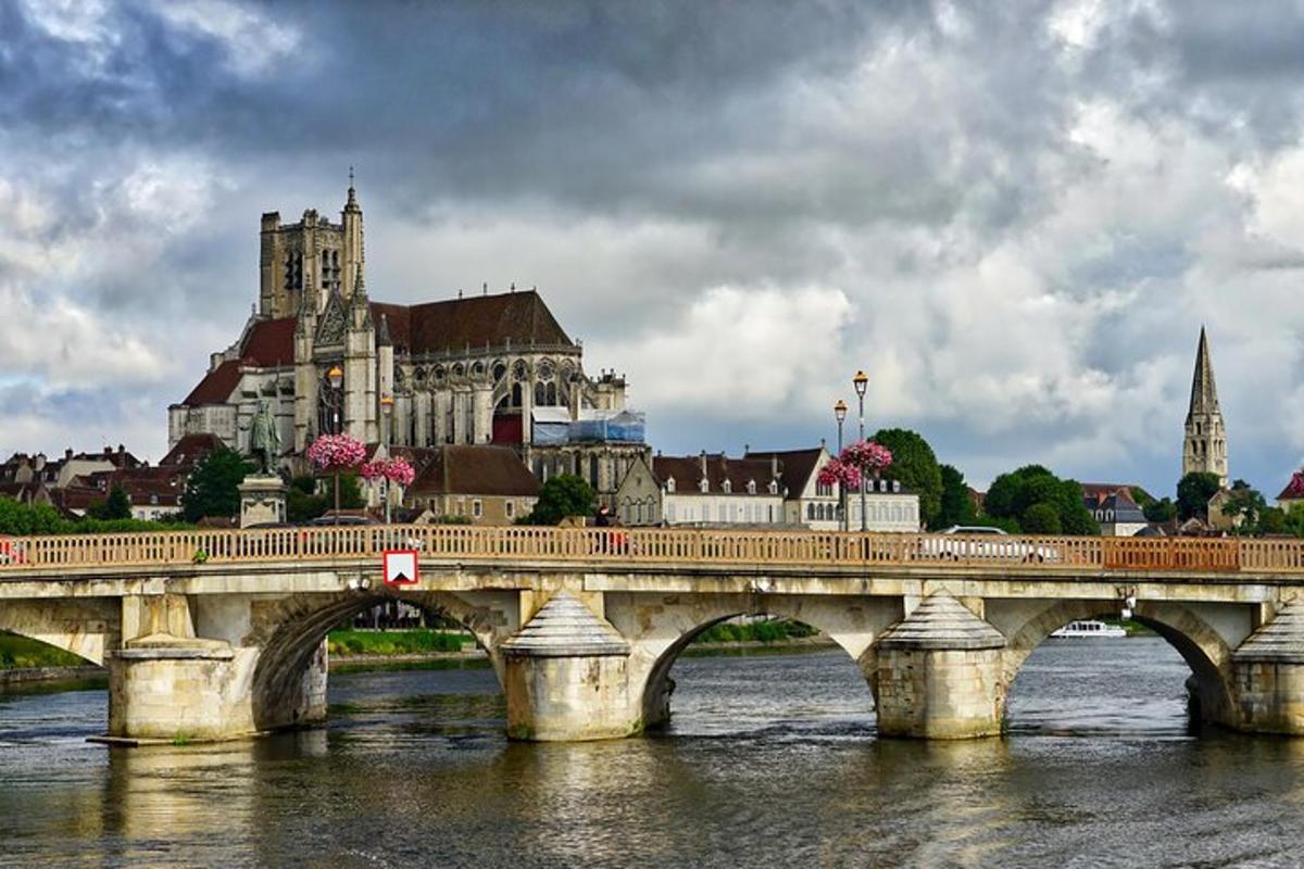 a bridge over a river with a large building
