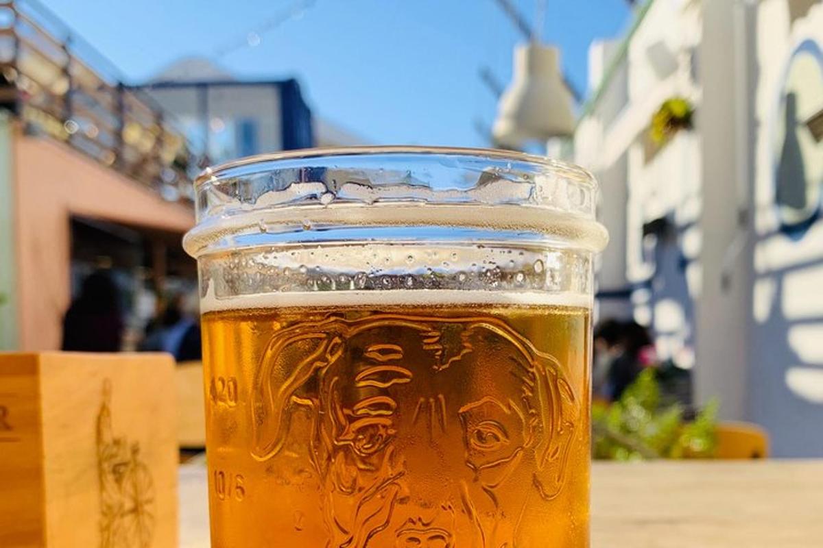 a glass of beer sitting on a table