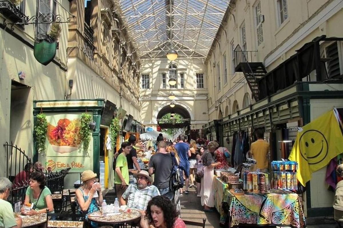 a group of people walking around a market in a building