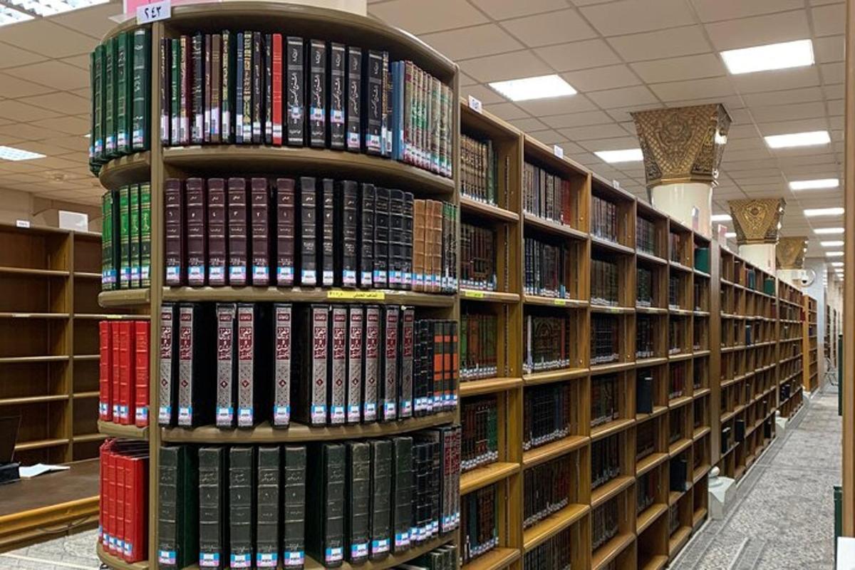 a stack of books on shelves in a library