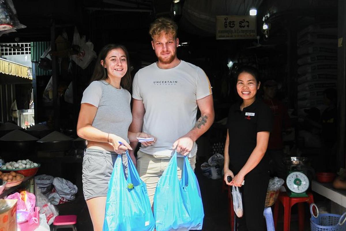 a man and two women holding shopping bags