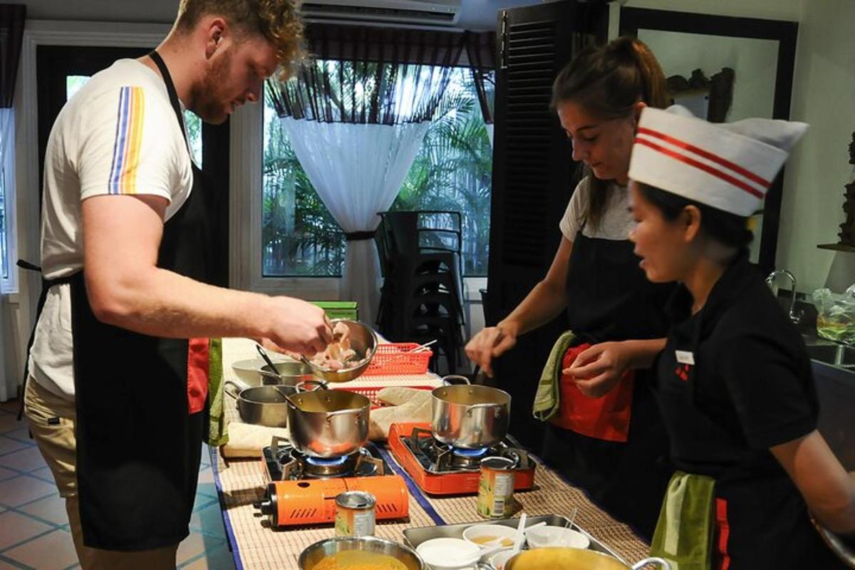 a group of people standing in a kitchen preparing food