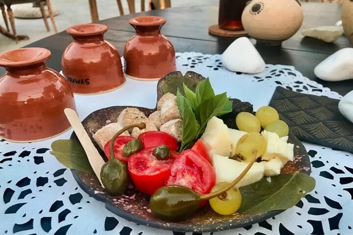 a plate of fruit on a table with vases