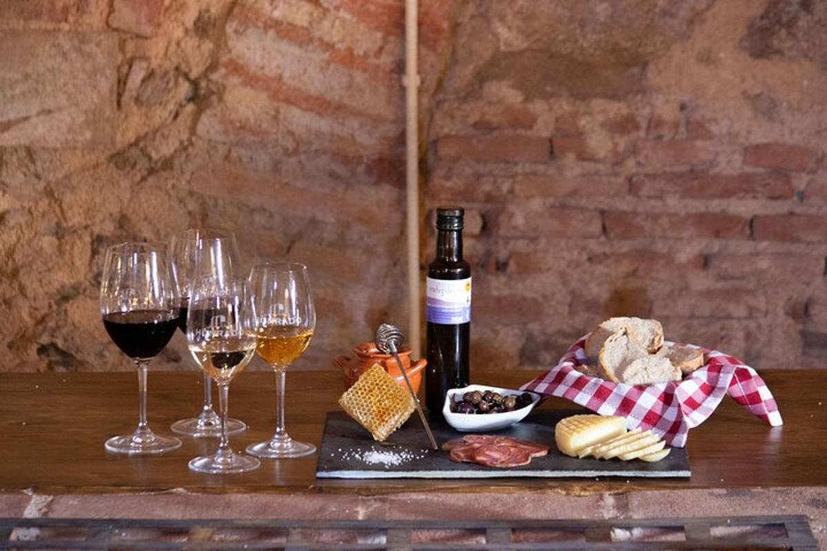 a table with glasses of wine and bread and cheese