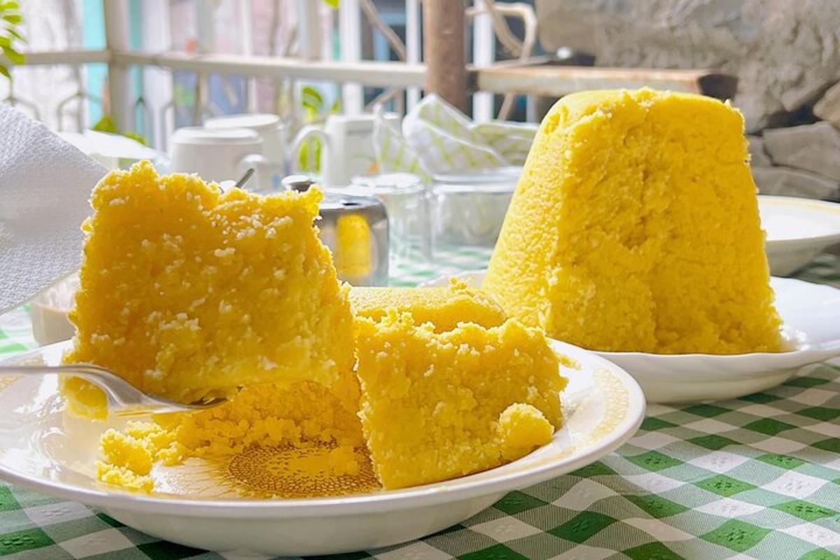 two pieces of yellow cake on a plate on a table