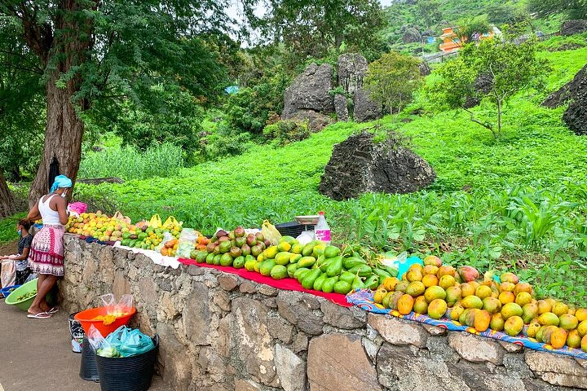 a woman standing next to a table of fruits and vegetables