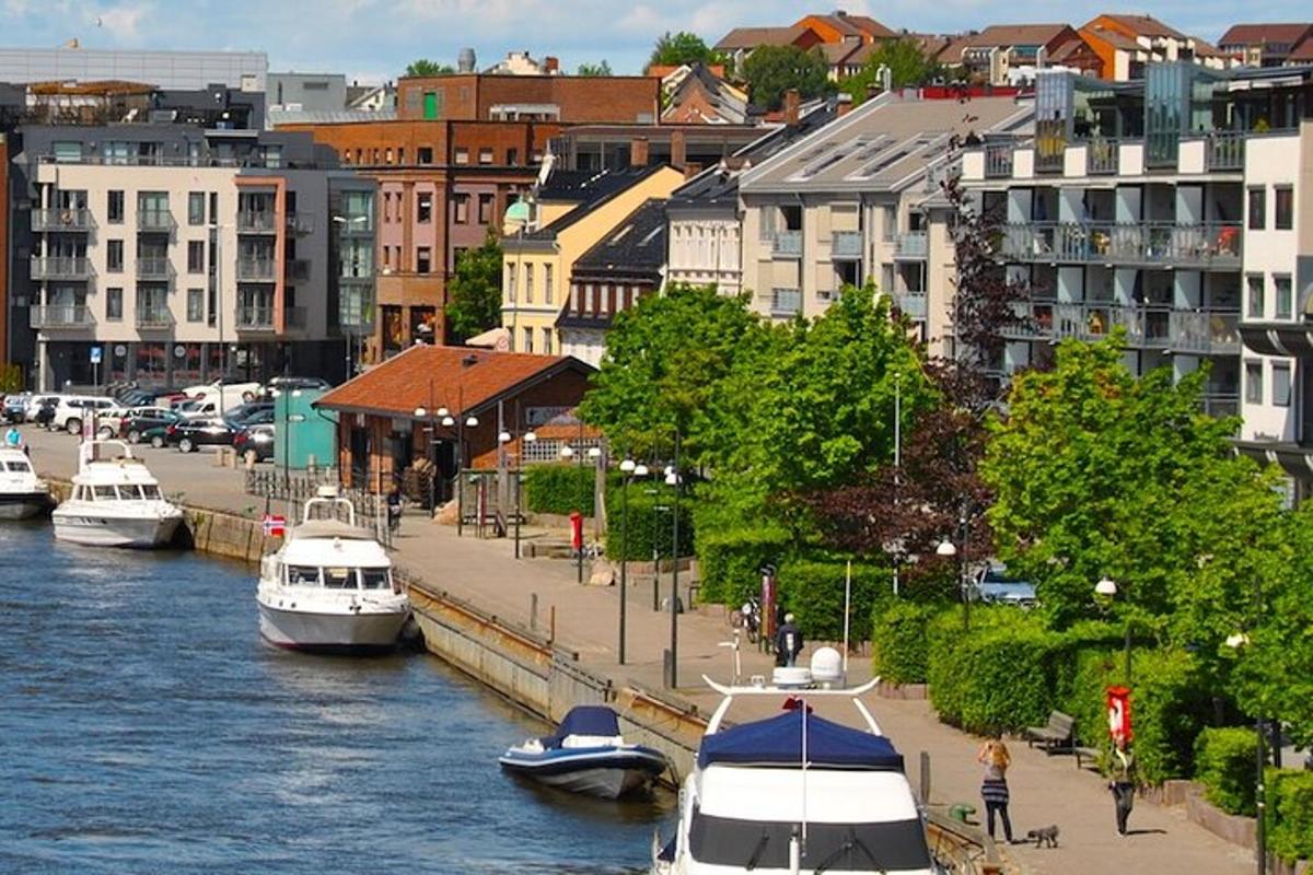 a group of boats docked in a river with buildings