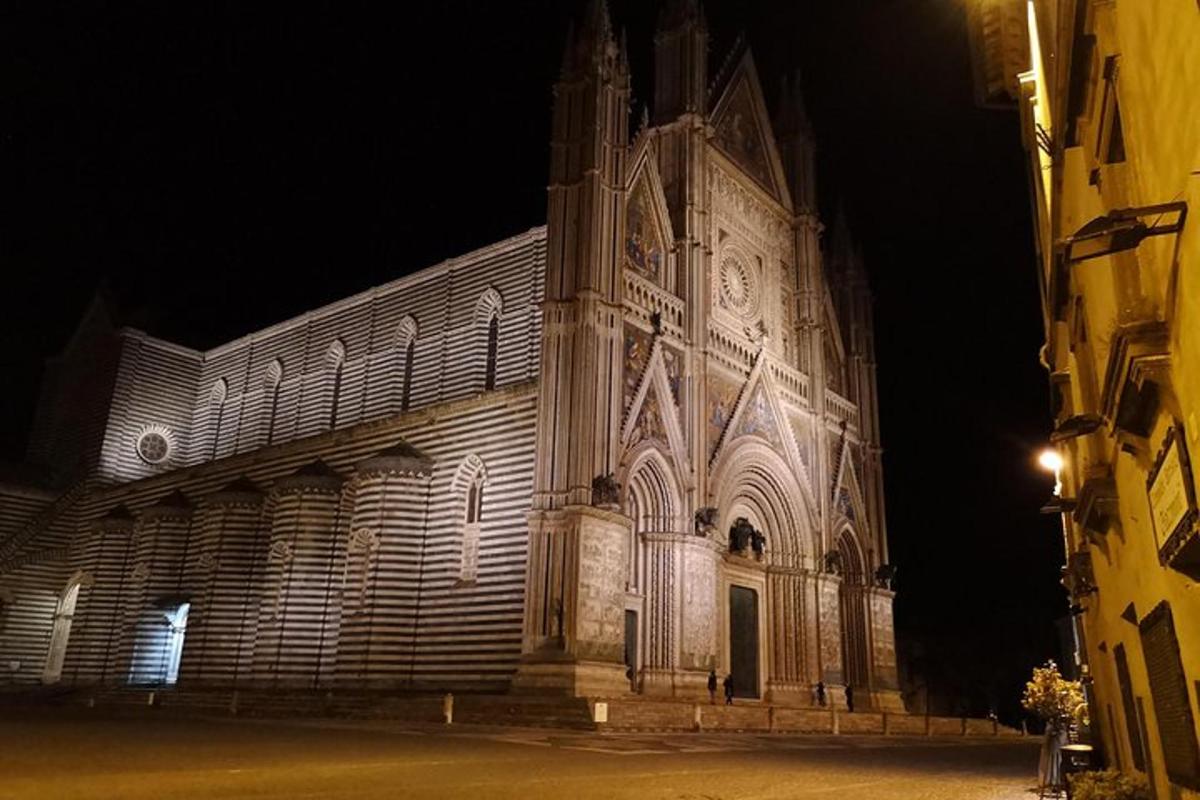 a large building with a clock tower at night