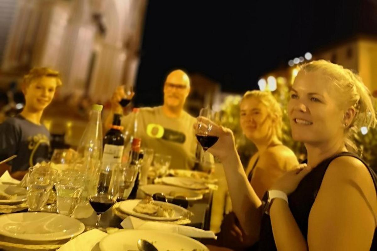 a group of people sitting at a table with wine glasses