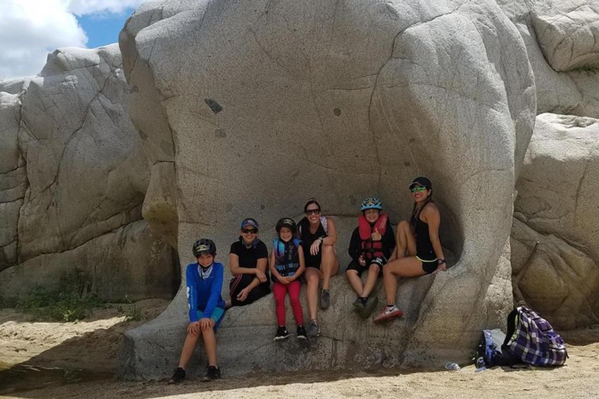 a group of people sitting in a rock formation