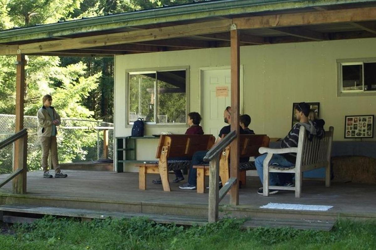 a group of people sitting on the porch of a house