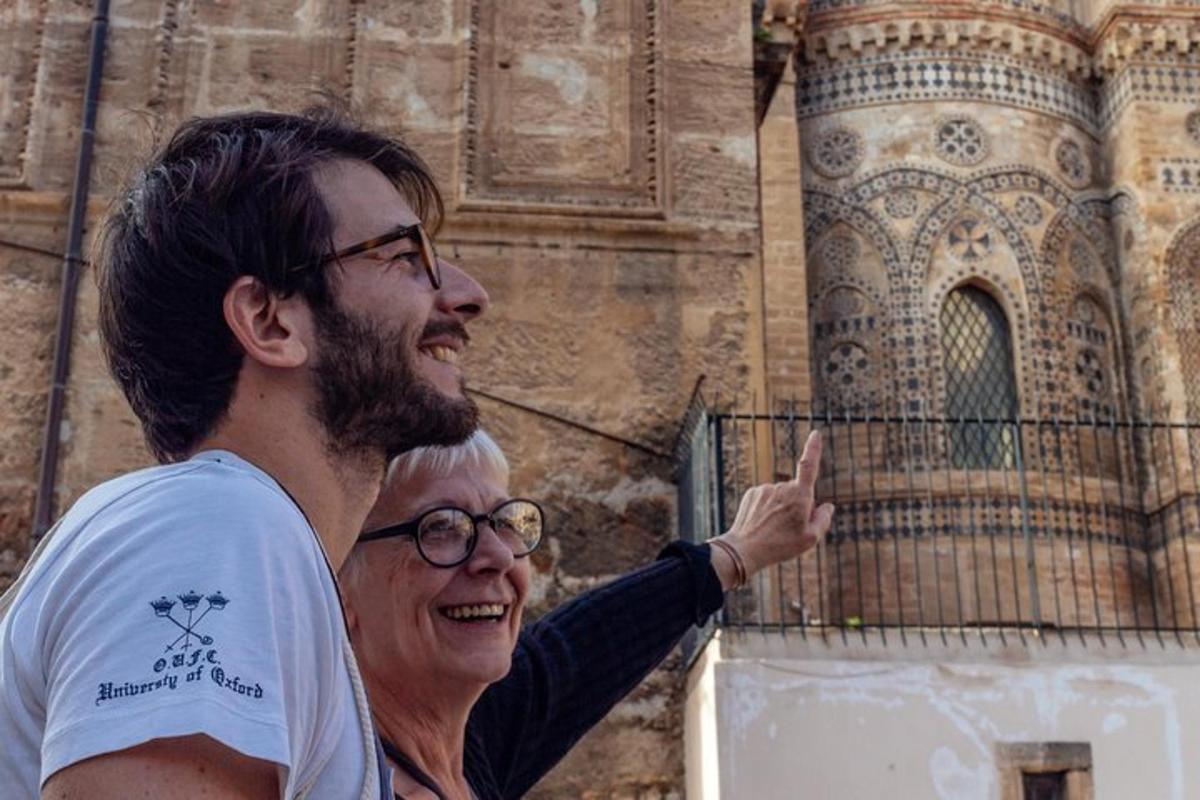 a man and a woman standing in front of a building