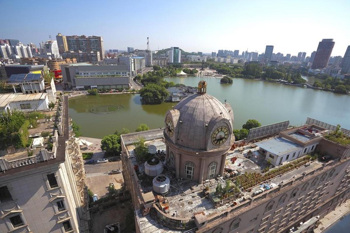a building with a clock tower next to a river