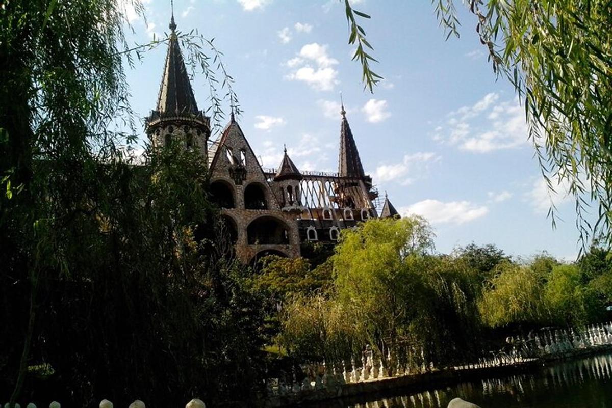 an old building with towers on top of a river