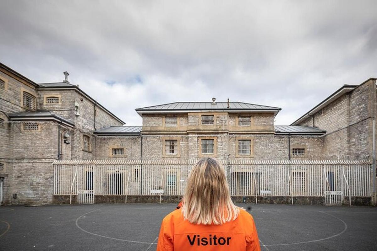 a woman is standing in front of a building